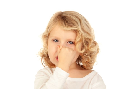 A girl covering her nose