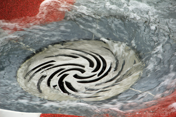 Water flowing down the drain.