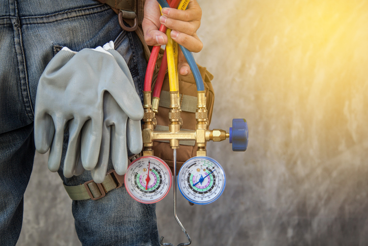 heating and air conditioning technician with tools