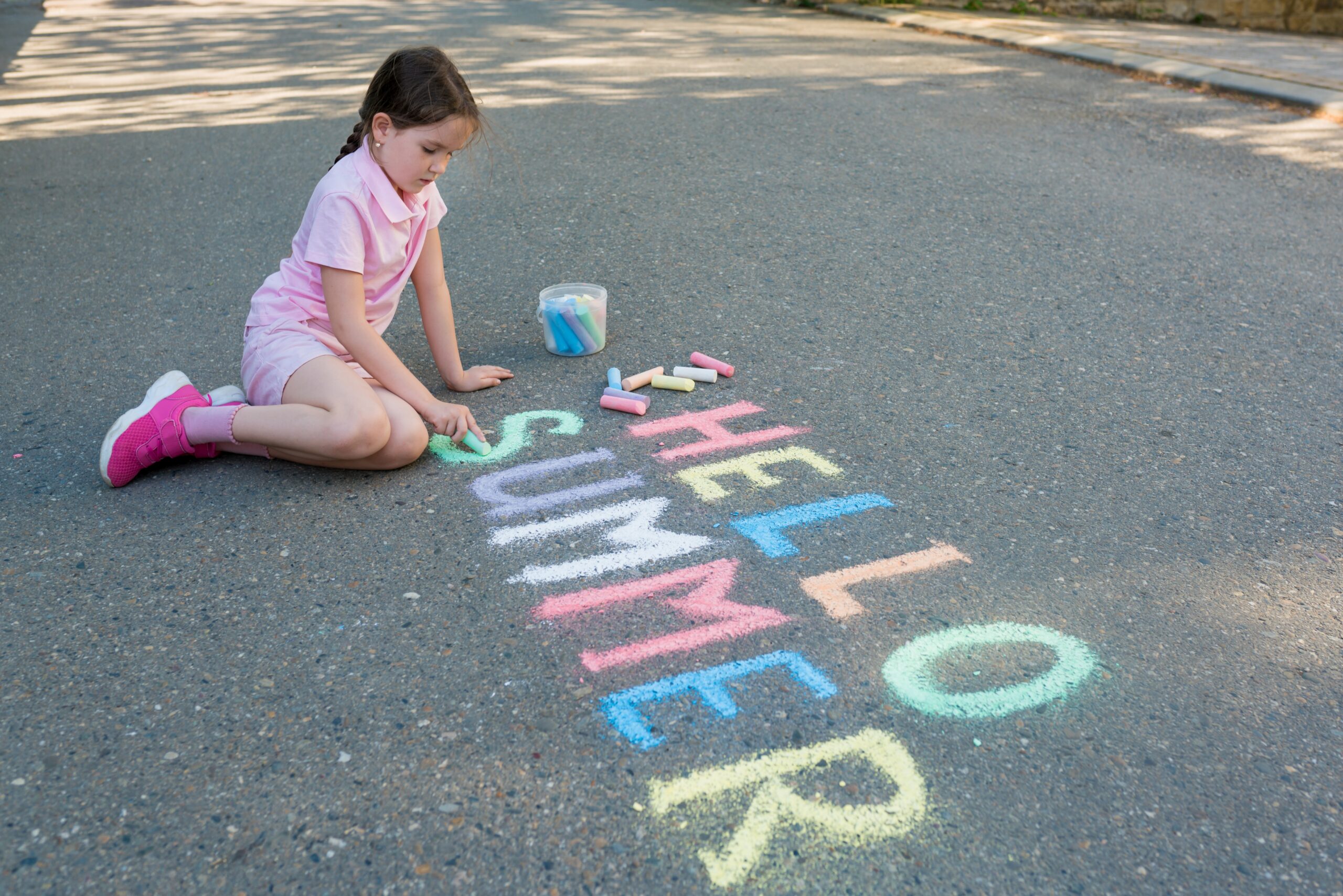 A girl writing along the road