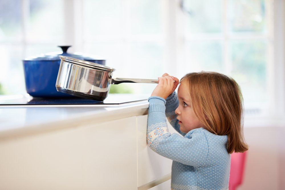 Little girl holding a pot